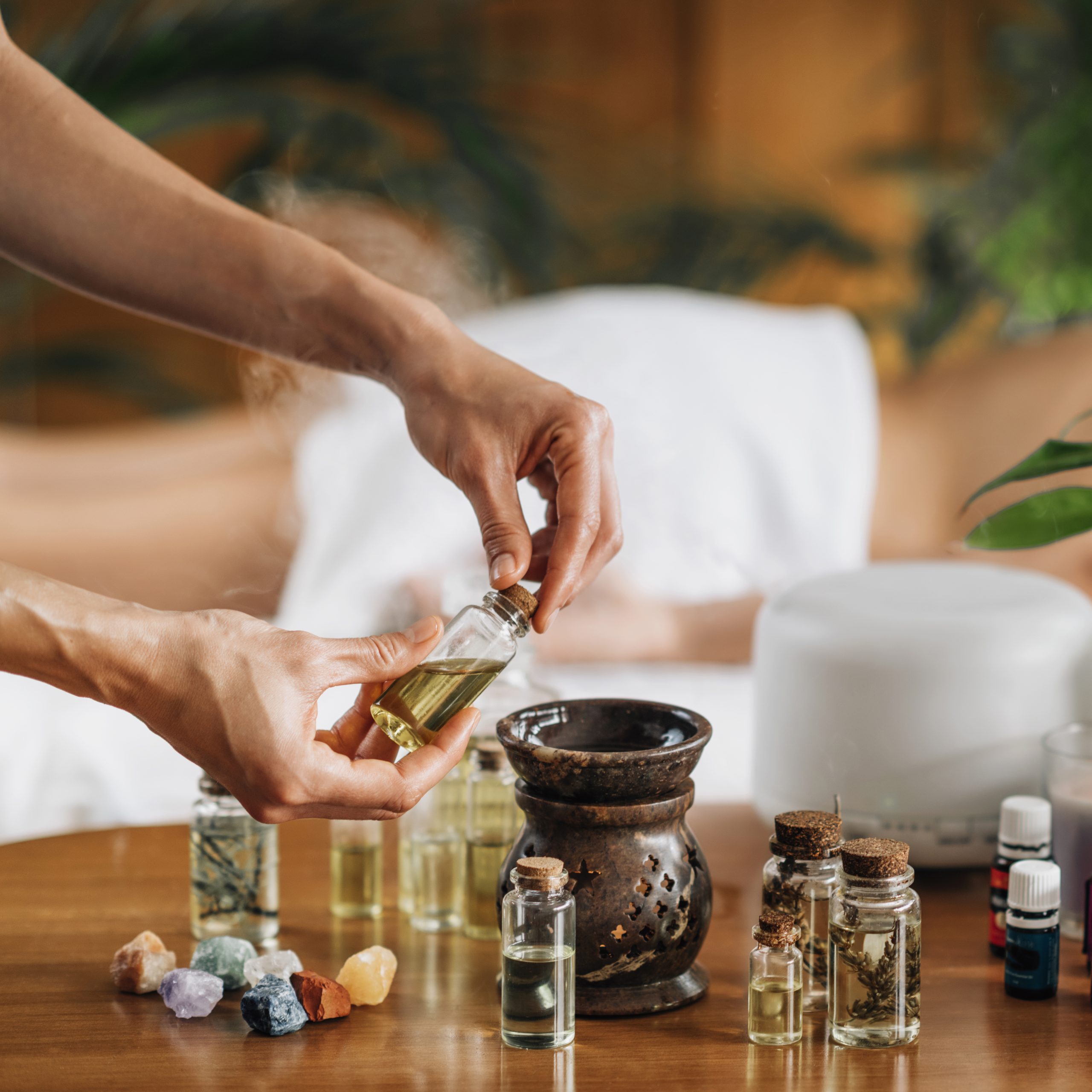 ayurveda aromatherapy massage pouring aromatic oil essential oil diffuser scaled